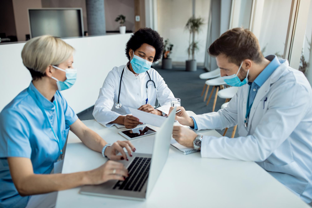 Healthcare providers reviewing a patient's medical report together at a clinic